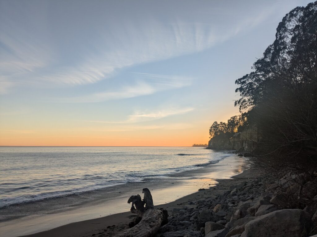 Its purpose is to show some of This is an image of a beach and the ocean at dusk. Its purpose is to show the colors of dusk which the somatic coach likes, and offer the reader a pause for reflection with an aesthetically pleasing image.